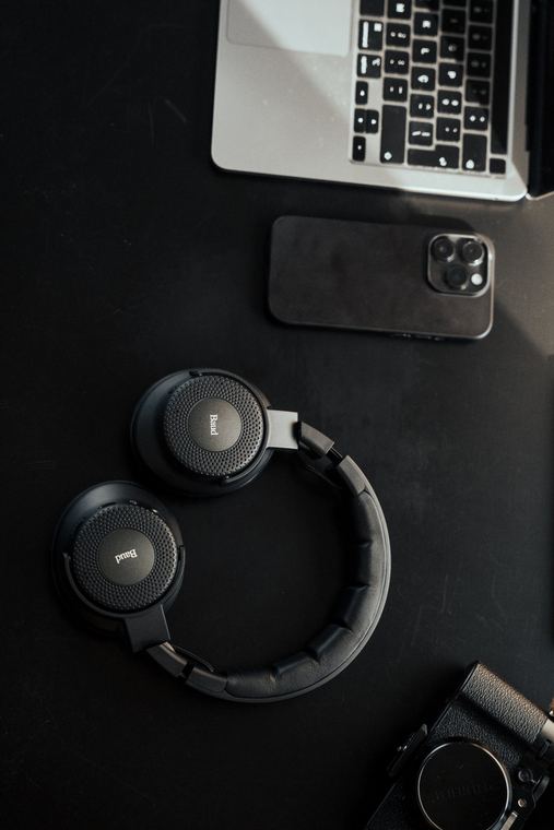 Baud headphones from above with laptop, phone and camera