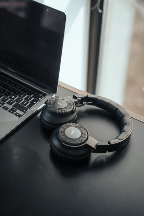 Baud headphones next to an open laptop
