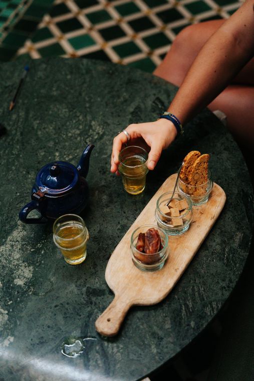 Mint tea with a blue teapot, dates and biscuits