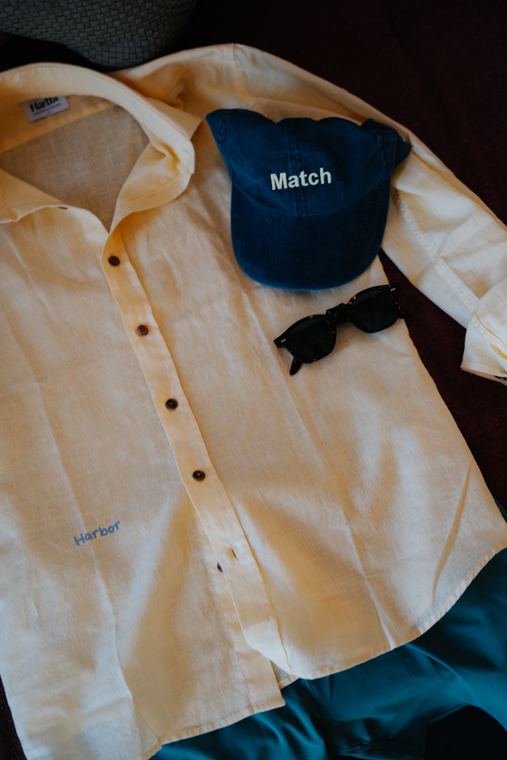 Yellow Harbor shirt with a cap and sunglasses, flat lay