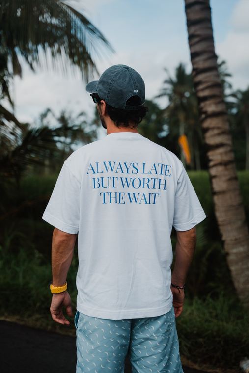 White t-shirt and blue shorts among palm trees