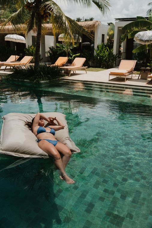 Floating in the pool with the villas behind